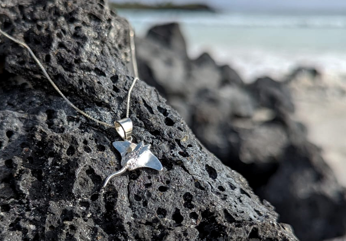 Manta ray pendant on lava rock at beach