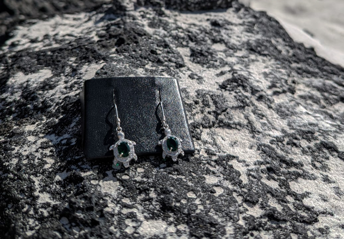 Tortoise earrings with green gemstone on lava rock